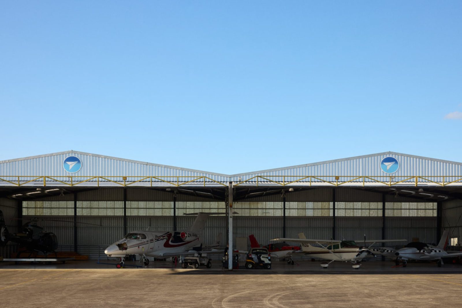 Hangars with planes inside on a clear sunny day