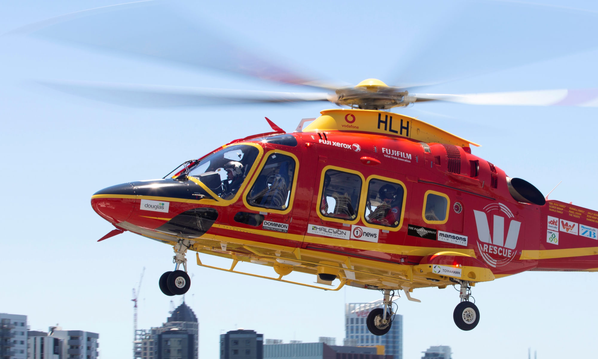 Westpac rescue helicopter flying with city background