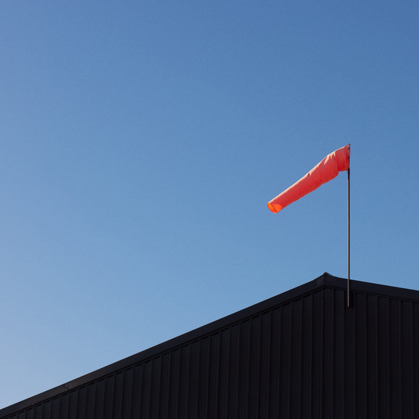Ardmore red wind indicator flag with clear blue skies